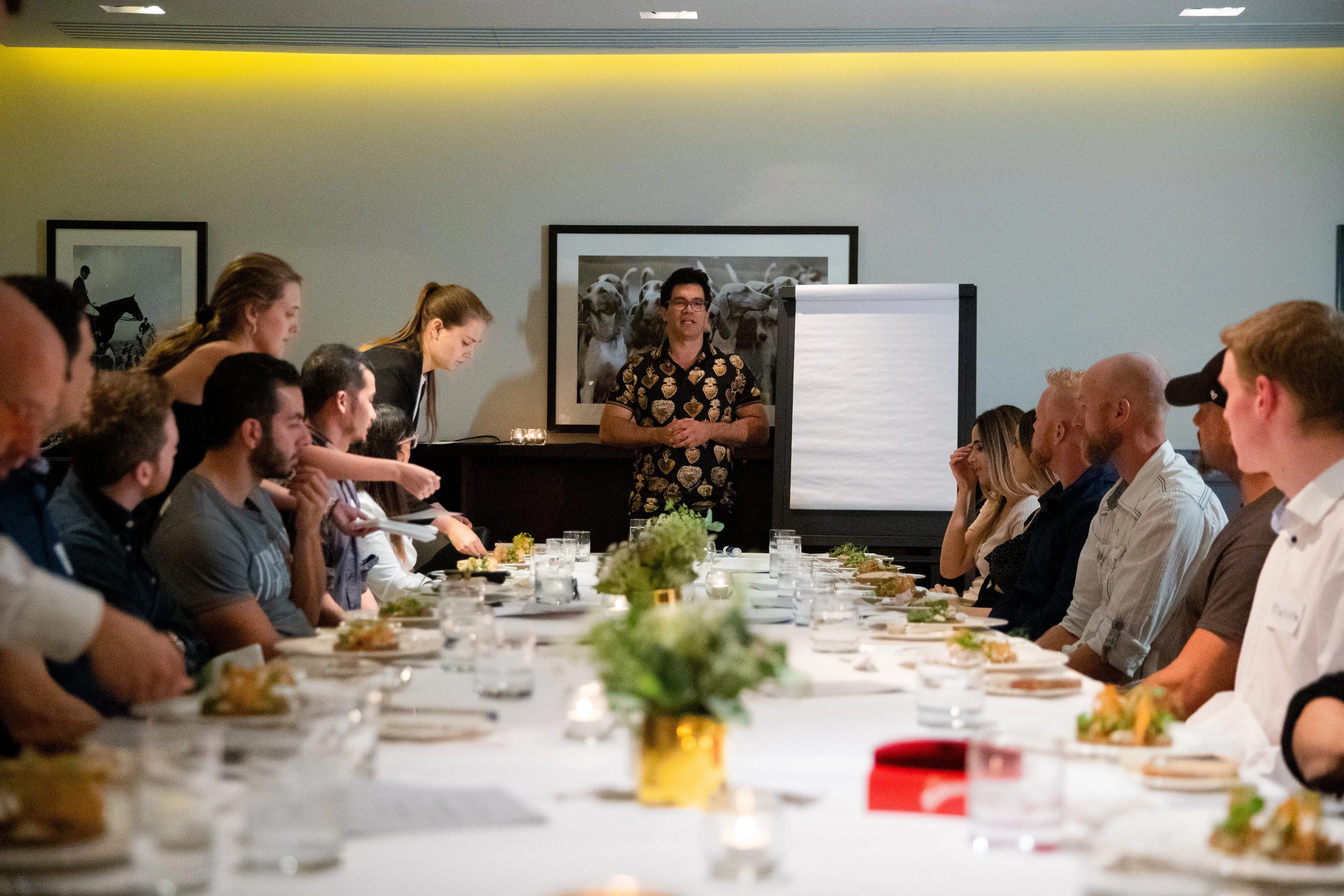 Tai Lopez presenting at the boardroom table with entrepreneurs